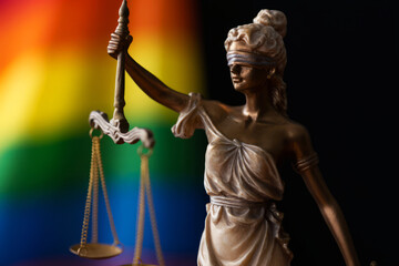 Blindfolded Lady Justice Holding Scales Against Colorful Background Symbolizing Equality