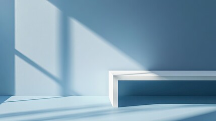 Obraz premium Blurry spotlight on a smooth blue wall with a table and soft shadows, creating a serene winter scene for branding products.