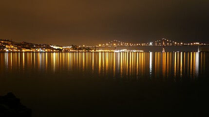 Obraz premium Night view of the Vasco da Gama Bridge, its glowing lights reflecting on the Tagus River, creating a serene urban landscape in Lisbon