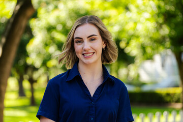 Happy businesswoman employee smiling for headshot portrait outside