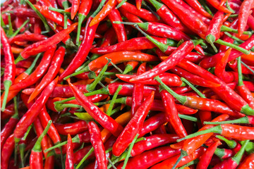 Vibrant heap of ripe red chili peppers, essence of spicy cuisine, fiery flavor of Capsicum annuum. Closeup of fresh chilies essential gourmet cooking ingredient in any healthy kitchen.