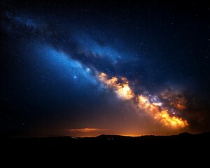 Fototapeta premium Majestic Milky Way galaxy over dark landscape at night.
