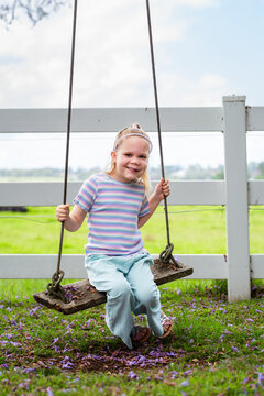 Six year old child swinging on swing in country with genetic condition lymphatic malformation