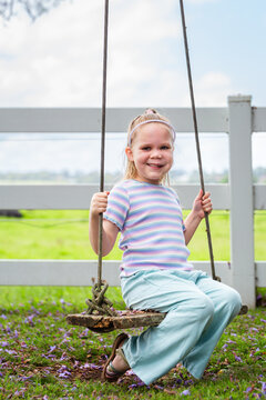 Six year old child swinging on swing in country with genetic condition lymphatic malformation