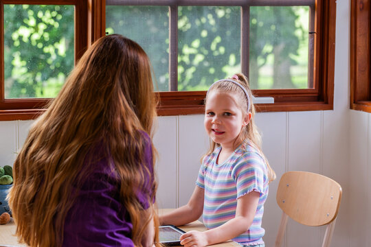 Speech therapist professional with child using technology to help with language development