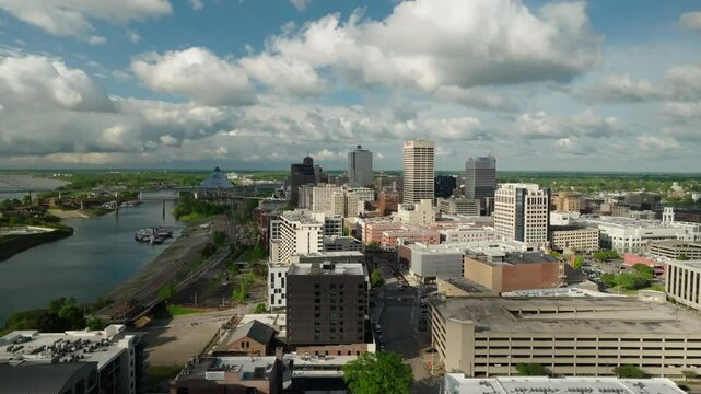 Aerial Panning Shot Of River By Residential Buildings In City Under Clouds On Sunny Day - Memphis, Tennessee
