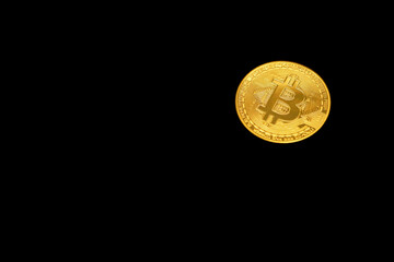 Golden Bitcoin coin on a black background, symbolizing cryptocurrency and digital finance. Interesting due to the growing importance of Bitcoin in the financial world. Isolated on black.