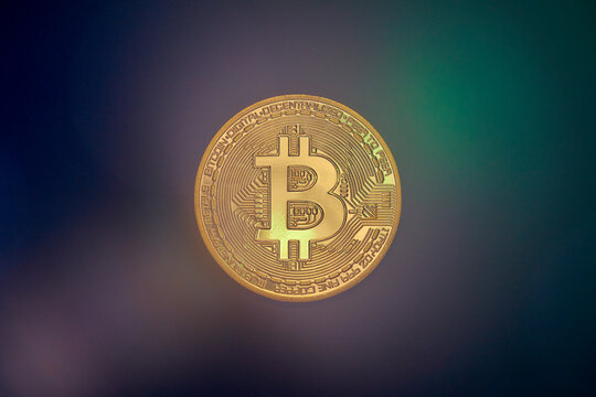 Golden Bitcoin coin with logo in the center and a digital pattern in the background. Symbolizes cryptocurrency and digital finance. Isolated on black. - Powered by Adobe