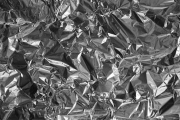 Processed collage of shiny metal silver gray foil crumpled packaging material texture