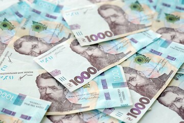 Big amount of ukrainian new one hundred hryvnia money bills with modern design. Financial concept, business