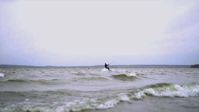 Man do tricks with his board practicising kitesurf jump in the air