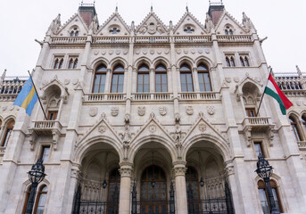 Flags on building of the Hungarian Parliament in neo-Gothic style