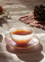 A warm cup of tea sits on a delicate saucer