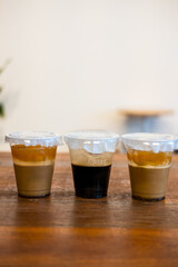 Set of ice coffee, ice black coffee and ice latte coffee with milk on table