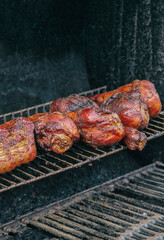 turkey meat row of legs fried with appetizing crust on a grill grill
