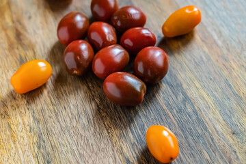 scatter tombets dark red chin with yellow on the edges of the wooden background