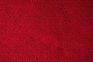 Wool fabric laid out flat in stockinette stitch. A close-up of the back of a sweater knitted in...