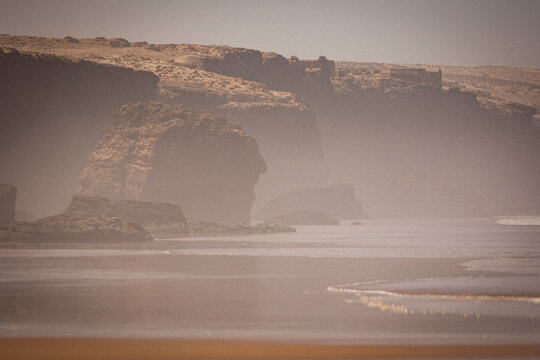 Hazy landscape of cliffs above the Moroccan shoreline