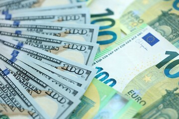 Big pile of Euro and USD banknotes. Many european and united states dollars