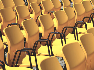 rows of yellow seats of an audience in bright light