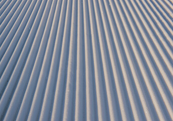 Obraz premium close-up of a groomed ski slope with striped relief