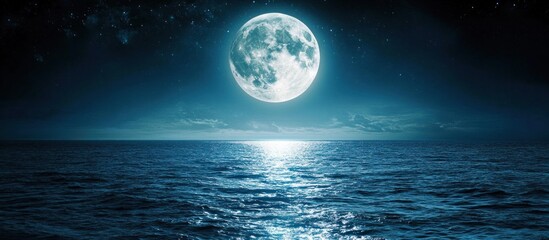 Full moon over calm ocean at night.