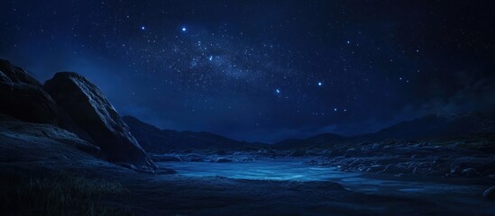 Naklejka premium Serene night landscape with starry sky over tranquil water and rocky shoreline.