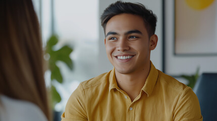 Asian professional in casual office conversation. Ideal for workplace culture, team collaboration, or modern communication content.