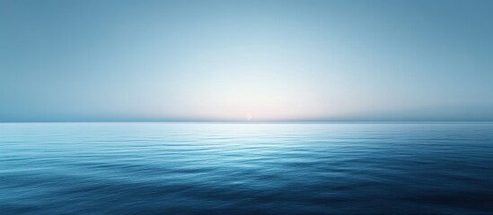 Obraz premium Calm ocean at sunrise with a serene, tranquil atmosphere.