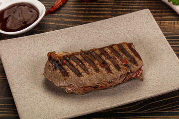 Grilled beef striploin steak with sauce