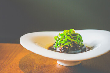 chopped slices of century Eggs With Grilled Chillies served in white plate