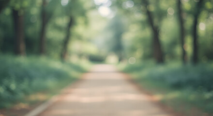A blurry image of a winding park trail surrounded by soft, verdant greenery