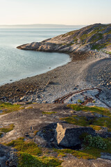 Beautiful and calm summer evening by the sea on the rocks. Varangerfjorden, Sør-Varanger, Northern Norway