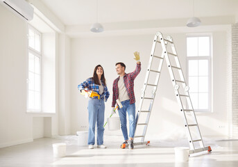 Happy family couple collaborates at home, planning a renovation project and working together on construction details, reflecting their relationship and shared vision for the future.