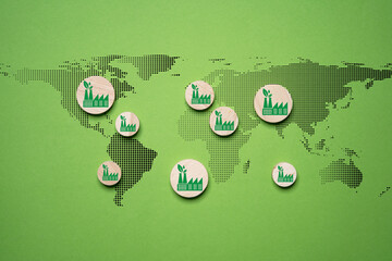 Green factory print screen on wooden block on world map and green background for green economy to reduce carbon dioxide emission from Kyoto protocol within 2050 ,Sustainability environment concept. © Dilok