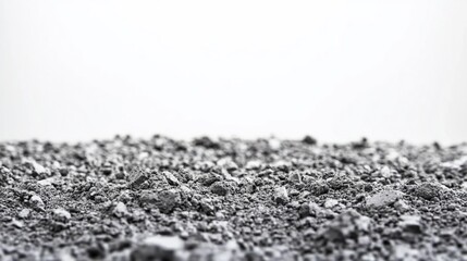 Close-up of grey, coarse, granular texture against a white background.