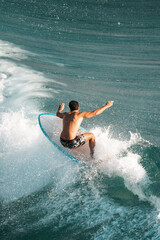 Surfing the waves, surfer catches an awesome wave on a surf board