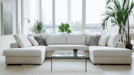 Fototapeta premium Bright modern living room with white sectional sofa, glass coffee table, and minimalist decor in natural light..