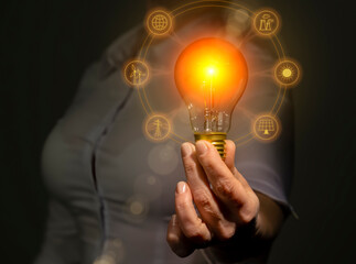 Electricity energy sources concept, power industry, hand holding light bulb with electricity extraction icons