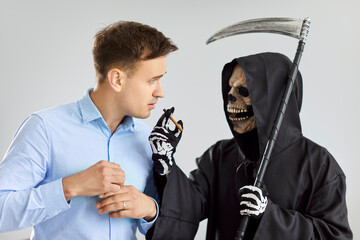 Death offering an unhealthy habit to a naive man. Grim Reaper in a black cloak holding his scythe...