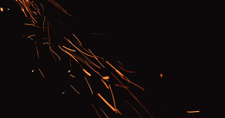 hot sparks falling from above black background