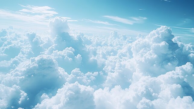 A breathtaking aerial view of fluffy white clouds stretching across a serene blue sky creating an ethereal and peaceful atmosphere