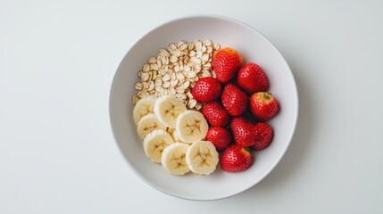 A vibrant bowl featuring sliced bananas, fresh strawberries, and oats, perfect for a healthy breakfast or snack.