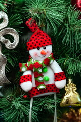 Christmas toys on an artificial Christmas tree close-up