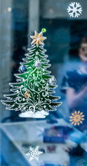 Christmas colored stickers on glass close-up