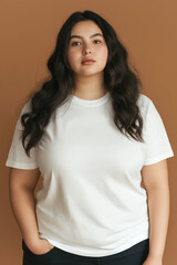 Obraz premium plus sized woman in white tshirt with wavy hair on brown background