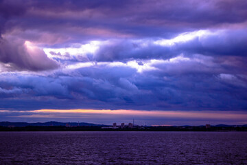 Dramatic sky with dark clouds over the city at sunset.