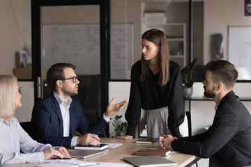Male boss leading negotiations, conducting collaborative meeting, explain agreement details,...