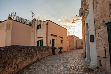 A street in the historical world heritage city of Matera, Puglia, Italy, la città dei sassi, in beautiful golden light, backlit image