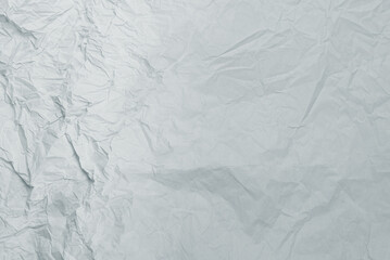 Crumpled white paper background.